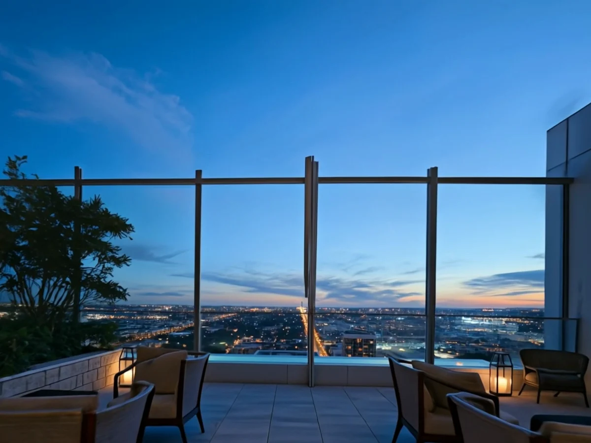 Private rooftop terrace with illuminated water edge above the night skyline